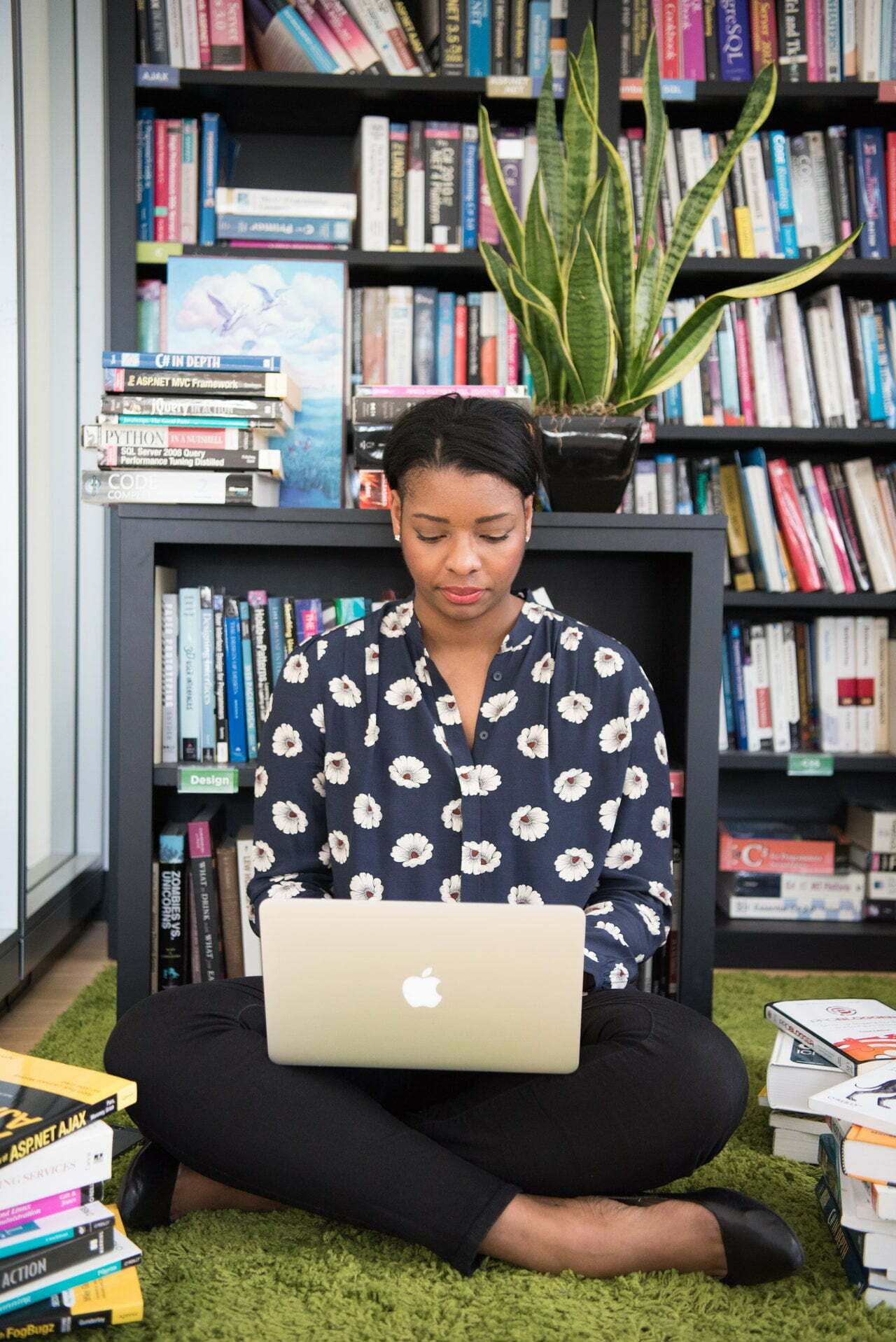 a person sitting on the floor with a laptop
